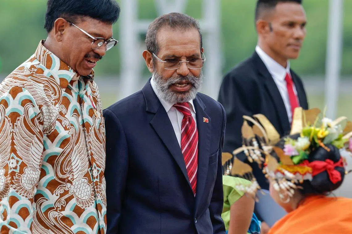 Timor-Leste Prime Minister Taur Matan Ruak (centre) is welcomed by Indonesian Minister of Communication and Information Technology Johnny Plate (left) at Komodo Airport, ahead of the 42nd Asean Summit in Labuan Bajo.