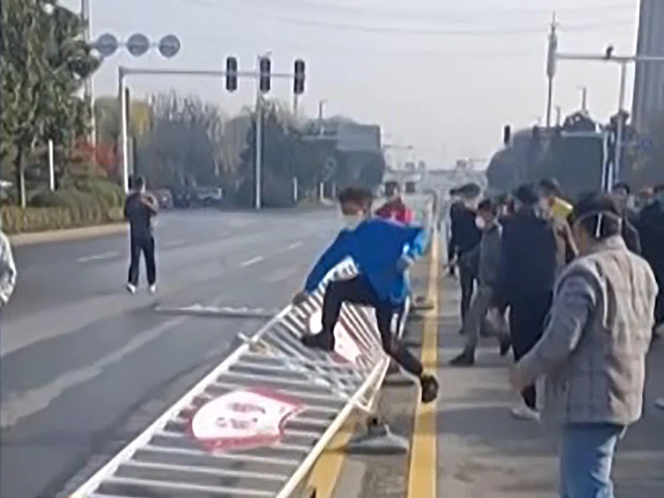 Workers at Foxconn’s iPhone factory in Zhengzhou in central China clashing with riot police. 