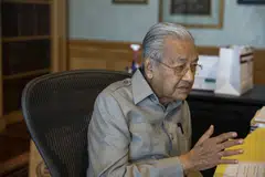 The currency may slide a further 5 per cent to a record-low 5 per US dollar, Mahathir Mohamad says. 