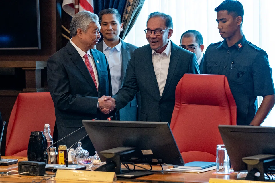 Prime Minister Anwar Ibrahim (centre) and Deputy Prime Minister Ahmad Zahid Hamidi at the first meeting with cabinet ministers in Putrajaya on Dec 5, 2022. Anwar said that he would not compromise on his pledge to fight corruption in Malaysia.