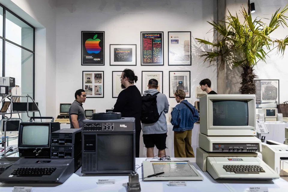 People visit the newly opened Apple Museum in Warsaw, Poland. The museum sets out to tell the story of the development of consumer electronics through the "successes and failures" of Apple.