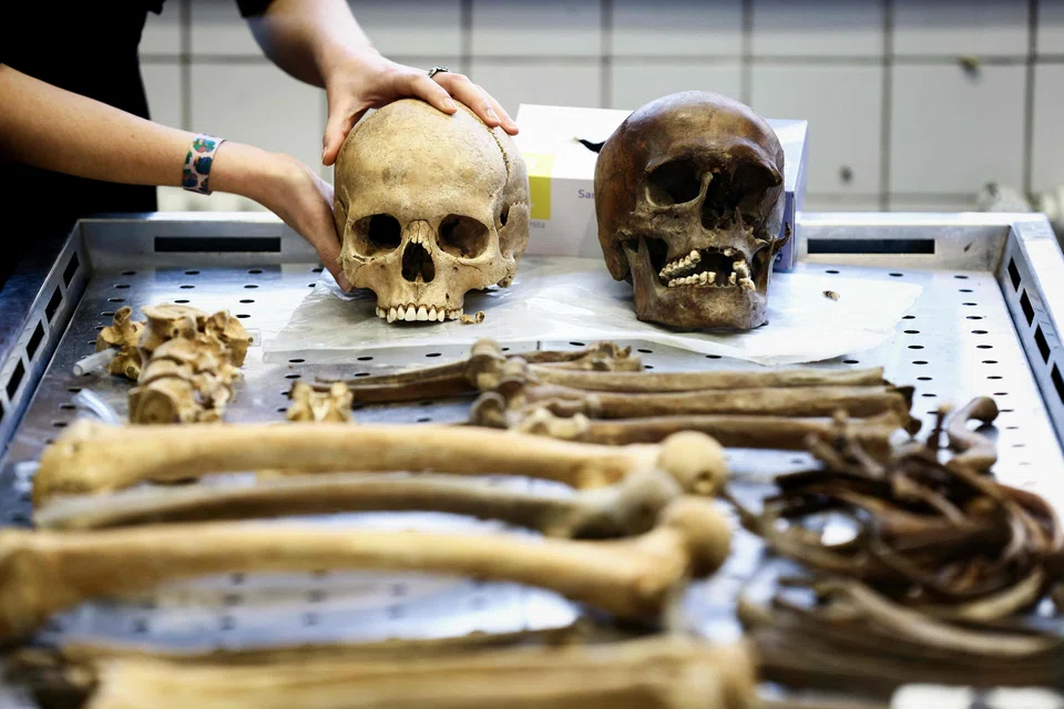 An anthropologist at the Forensic Medicine Institute in Liege, eastern Belgium, shows the skull of a soldier who fought in the Battle of Waterloo in 1815.