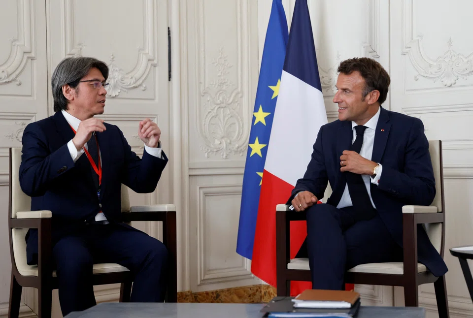 France's President Emmanuel Macron (right) speaks with ProLogium CEO Vincent Yang (left) during a meeting as part of the 5th edition of the "Choose France" Business Summit, in Paris, France, July 11, 2022. ProLogium has shortlisted four European countries  for an US$8 billion solid-state lithium battery plant.