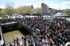 Protestors gather outside Place de la Republique to demonstrate against the French Government's pension reform hours after it was signed into law in Rennes, France, on April 15, 2023.