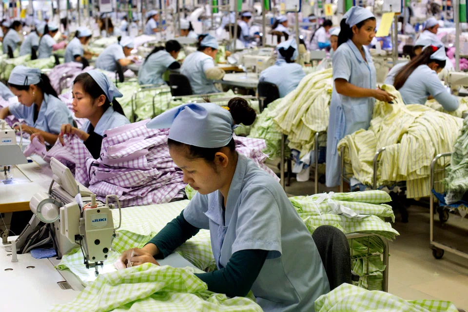 Labourers put together men's formal shirts at a  garment factory in Phnom Penh. Cambodia’s apparel industry has benefited from the trade war between China and the US, in which special tariffs were imposed on Chinese textiles in 2018. 