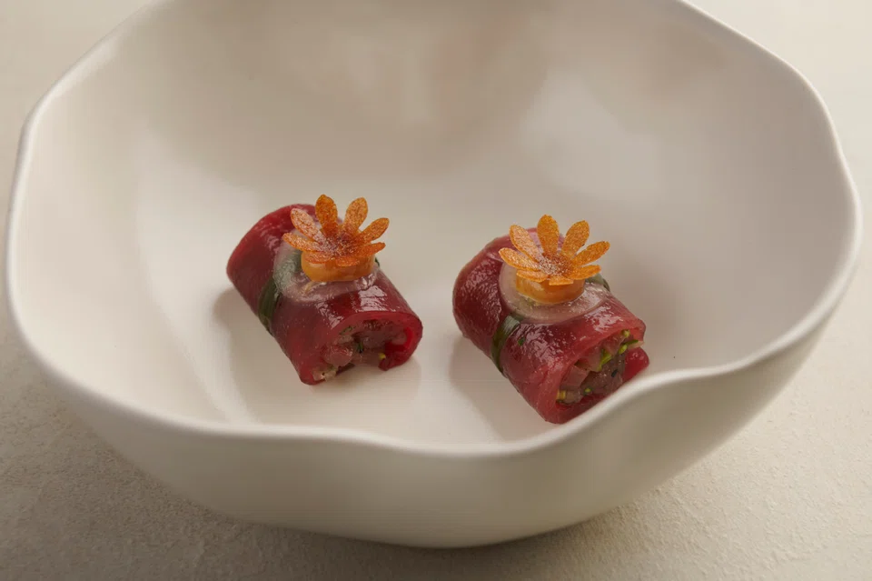 Bluefin tuna wrapped around kerabu salad with a fragrance of herbs.
