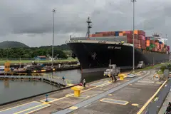 Ships passing through the drought-stricken Panama Canal are facing long waits, surcharges, and time and fuel-consuming detours around South America to avoid the delays.