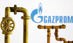 Model of natural gas pipeline and Gazprom logo, July 18, 2022. REUTERS/Dado Ruvic/Illustration