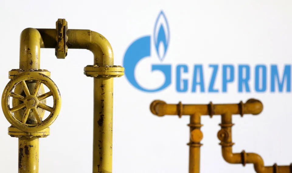 Model of natural gas pipeline and Gazprom logo, July 18, 2022. REUTERS/Dado Ruvic/Illustration