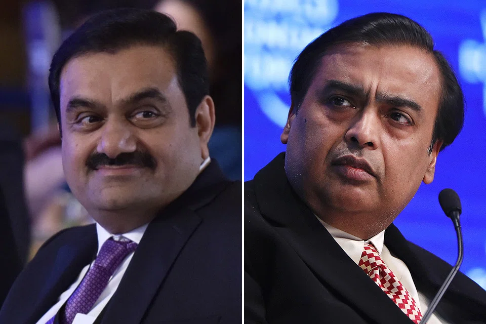 Gautam Adani (left) and Mukesh Ambani are profiting from a surge in global commodity prices triggered by Russia's invasion of Ukraine, burnishing their fossil-fuel credentials even as Asia's richest men publicly push their pivots toward greener energy.