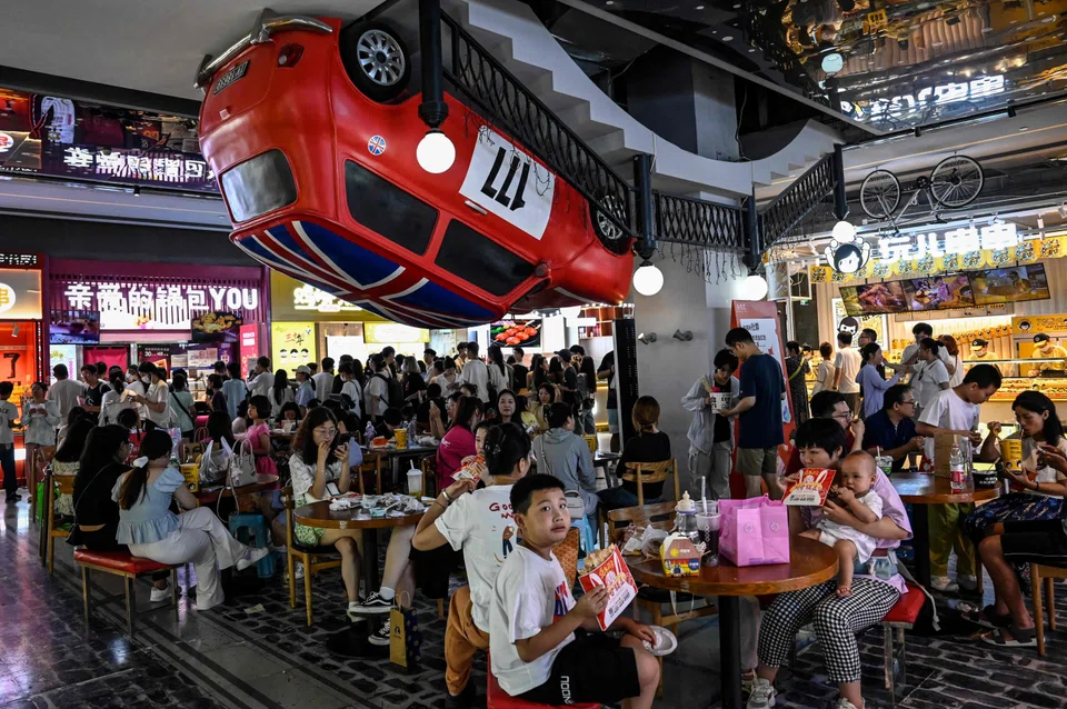 Diners at a shopping mall in Beijing on Aug 12.  China's hoped-for rebound has fizzled out, with the economy tumbling into deflation.