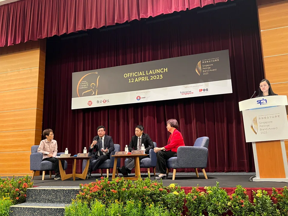 At the SPBA launch on Apr 12, Ling Huat Sing (second from left) and Peh Yi Han (second from right) – representatives of former winners Four Star Industries and Global Eduhub respectively – speak about their companies' experience of participating in the Award.