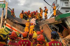 Firefighters work to rescue a person at the site of a collapsed 7-11 store after a magnitude 6.9 earthquake in Yuli township, Hualien County, Taiwan on Sept 18, 2022.