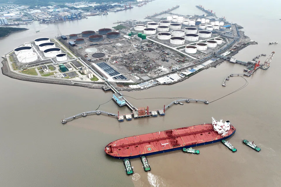 Tugboats helping a crude oil tanker to berth at an oil terminal, off Waidiao Island in Zhoushan, Zhejiang province, China, July 18, 2022. China is expected to account for around 40 per cent of the increase in global oil demand this year as its economy emerges from strict lockdowns.