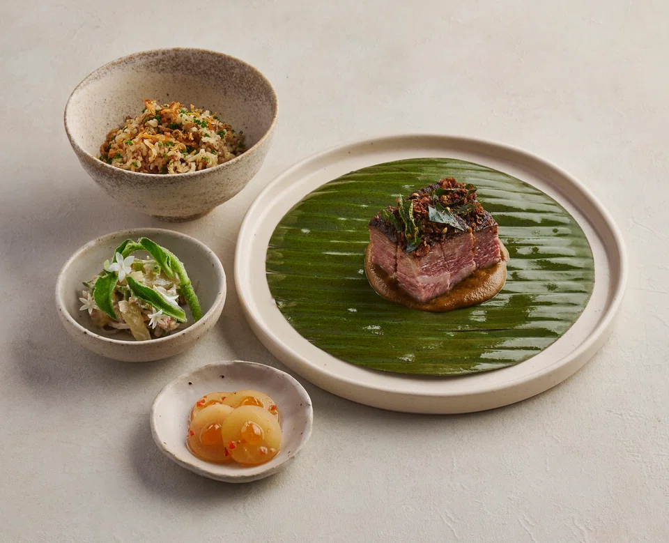 Nasi Dagang or Trader's Rice of red rice, short-rib percik and pickles.