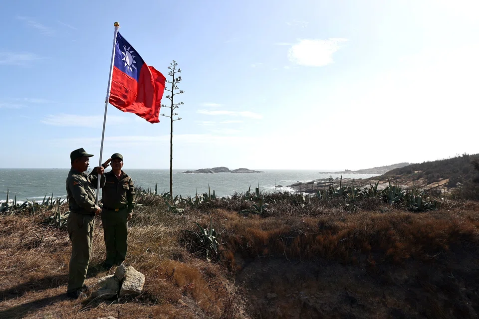 Veterans take part in a flag raising ceremony at a former military post on Kinmen, Taiwan, Oct 15, 2021. A Taiwan government-backed television station apologised after mistakenly reporting a Chinese attack in Taipei.