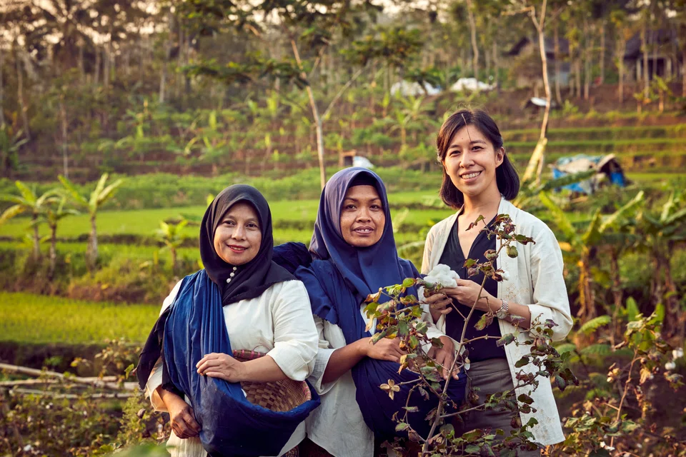 Rolex Awards for Enterprise laureate and founder of SukkhaCitta Denica Riadini-Flesch (extreme right) holding cotton harvested on a farm near Central Java, Indonesia, by two local women. 