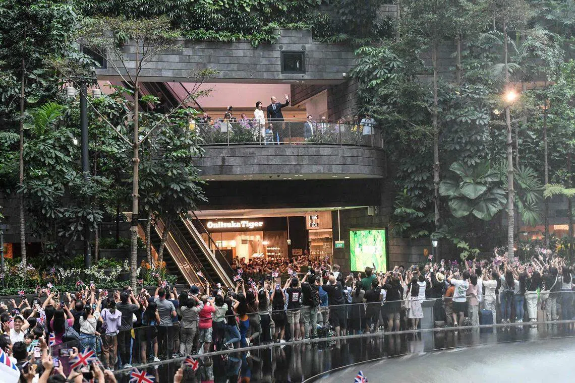 Prince William, accompanied by Senior Minister of State for Foreign Affairs Sim Ann, greeting people at Jewel Changi Airport shortly after his arrival on Sunday.