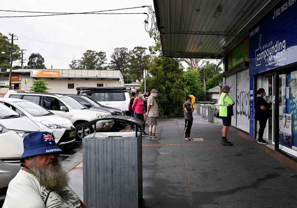 Customers queue outside a Western Sydney chemist to purchase Rapid Antigen Test kits in the wake of the Covid-19 pandemic in Sydney, Jan 5, 2022.  