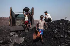 Day labourers loading coal into trucks at a coal mine in Jharkhand, India.   