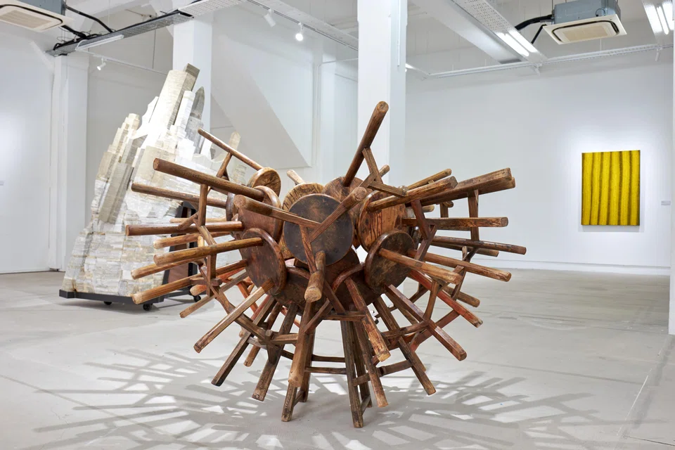 Pierre Lorinet and his artworks, including Ai Weiwei's installation titled Grapes (centre) made up of stools from the Qing dynasty.