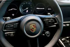 Volkswagen agreed to pay at least US$80 million to settle Porsche buyers' complaints that emissions and fuel economy test results were improperly skewed. 