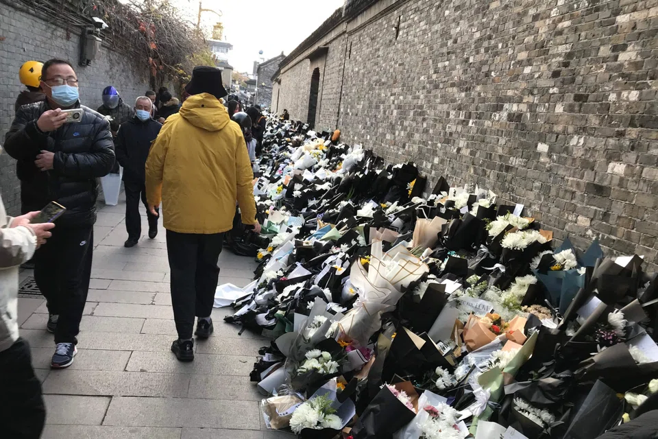 Flower bouquets placed by mourners are seen outside the old home of former Chinese leader Jiang Zemin, who died on Nov 30.