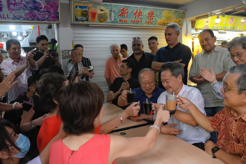 From far right, seated: Tan Jee Say, presidential candidate Tan Kin Lian and Dr Tan Cheng Bock at People’s Park Food Centre.