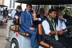 Canada's Prime Minister Justin Trudeau (centre) was due to return home on Sunday after laying a wreath at a memorial to Indian independence leader Mahatma Gandhi, but a mechanical fault kept him in India overnight.
