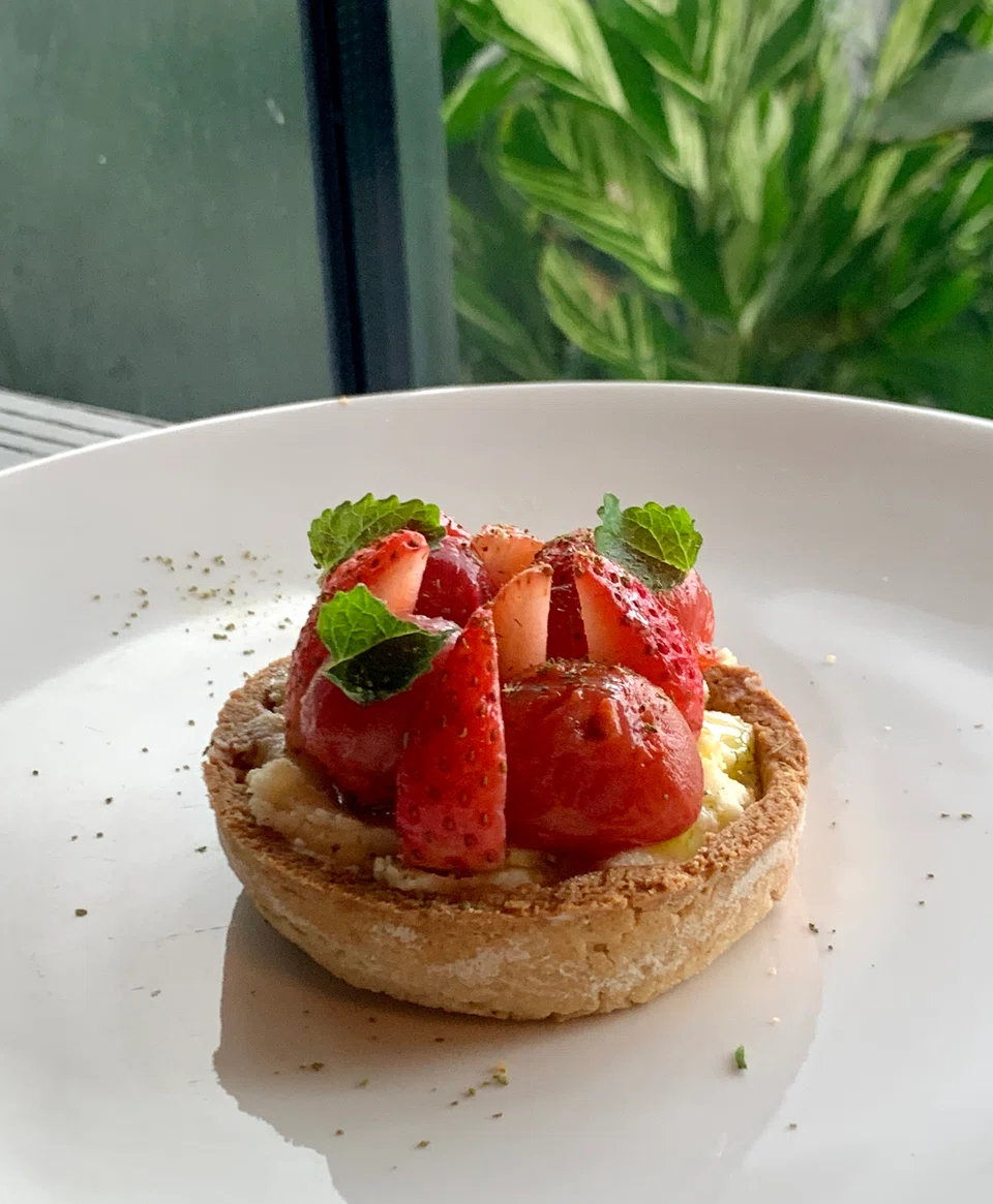 Tigernut tart houses comte cheese cream, smoked tomatoes and strawberries.