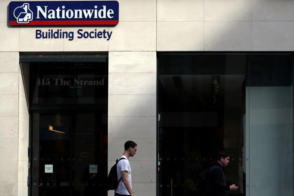 NATIONWIDE BUILDING SOCIETY reported its annual profit nearly doubled on Friday (May 20), but warned rocketing inflation in Britain could dent the economy and lower house prices.