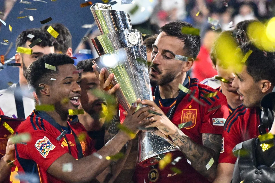 Spanish forward Joselu (centre) kissing the Uefa Nations League trophy after Spain's victory over Croatia in Rotterdam on June 18.