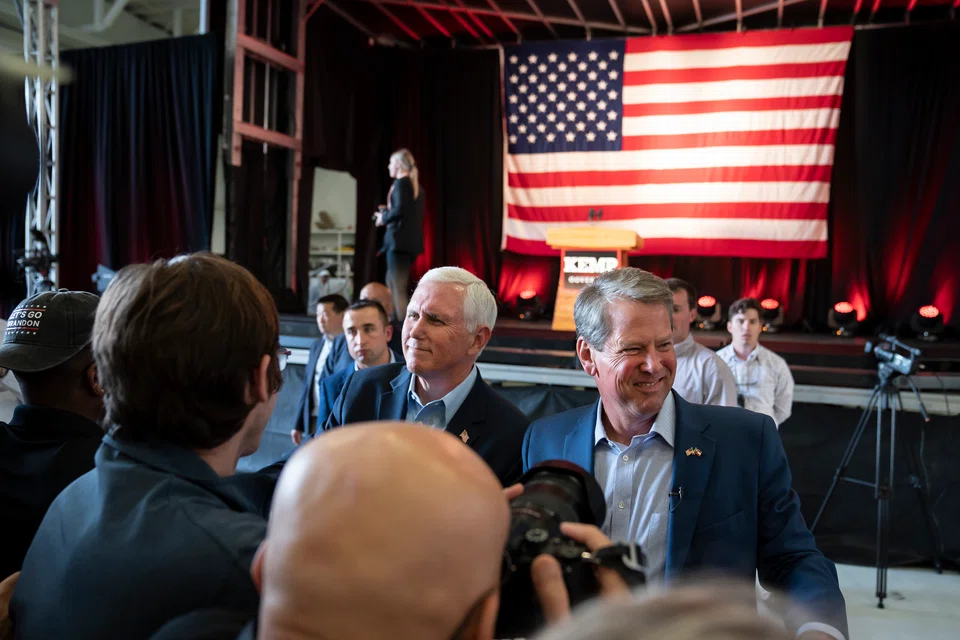 Former US Vice-President Mike Pence (left) and Governor Brian Kemp, at a campaign stop in Kennesaw, Georgia on May 23, 2022. 