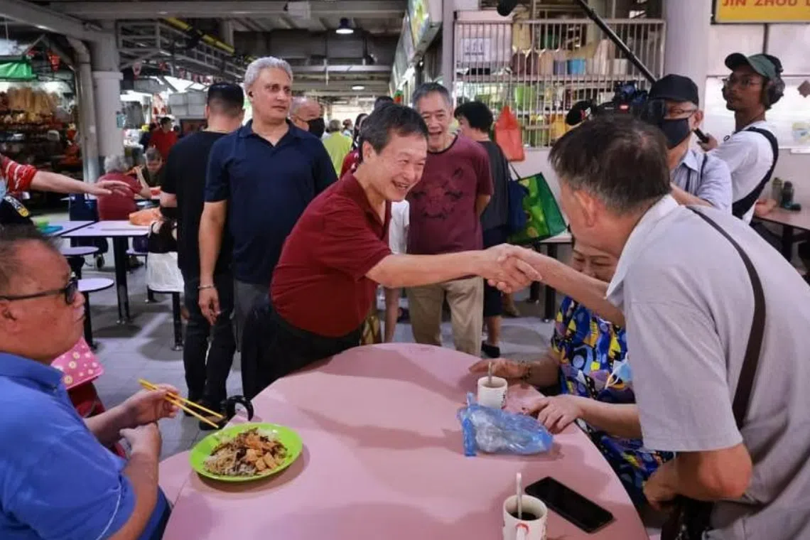 Presidential hopeful Tan Kin Lian (centre) meeting residents at Jurong West 505 Market and Food Centre on Aug 15, 2023. 