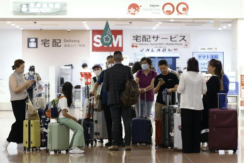 A group of Chinese tourists arrive at Haneda Airport in Tokyo. The ending of three years of Covid curbs has analysts predicting that the big three state carriers could return to profit in the second half of this year, halting a run of deep losses.