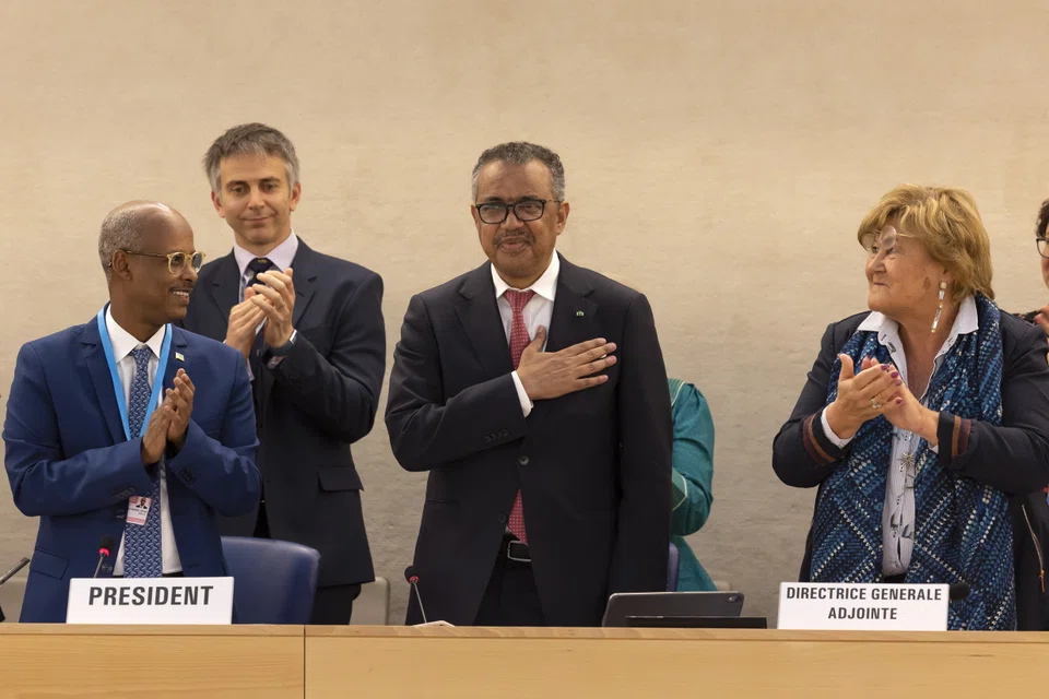 Tedros Adhanom Ghebreyesus (C) Director General of the World Health Organization (WHO) celebrates his reelection, during the 75th World Health Assembly at the European headquarters of the United Nations in Geneva, Switzerland.