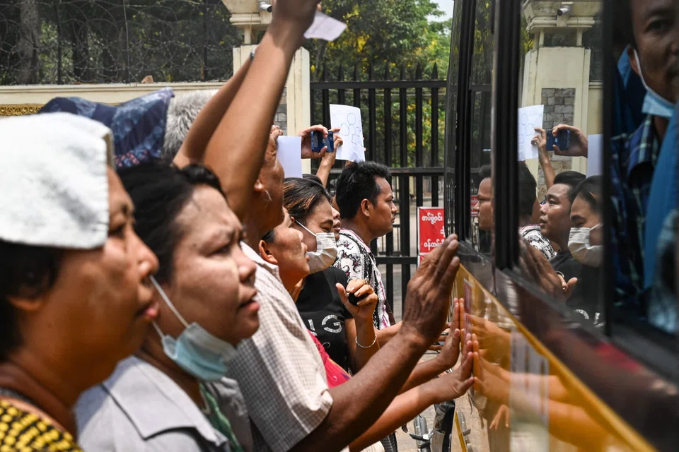 Relatives gather around a bus carrying prisoners being released outside the Insein prison in Yangon on May 3, 2023. Myanmar's junta announced on May 3 it had pardoned 2,153 prisoners jailed under a law that criminalises encouraging dissent against the military. 
