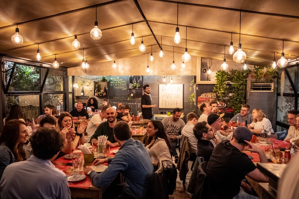 Diners at the new Pizzeria L'Elementare, which serves up thin-crust pizzas and craft beers, in Rome on May 5. 