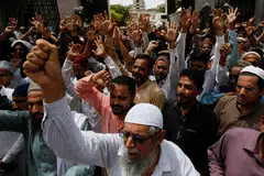 People raise their hands and chant slogans against the blasphemous comments on Prophet Mohammed by the members of the Indian Bharatiya Janata Party, during a protest in Karachi, Pakistan, June 10, 2022. 