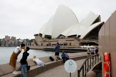 Chinese tourists pose for a photographer (not pictured) near the Sydney Opera House in a file photo. After three years of struggle and anticipation, the widely expected wave of returning Chinese tourists Down Under has turned out to be a trickle.
