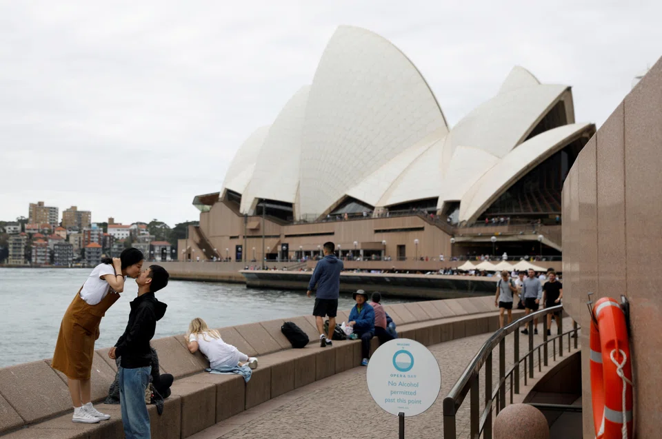 Chinese tourists pose for a photographer (not pictured) near the Sydney Opera House in a file photo. After three years of struggle and anticipation, the widely expected wave of returning Chinese tourists Down Under has turned out to be a trickle.