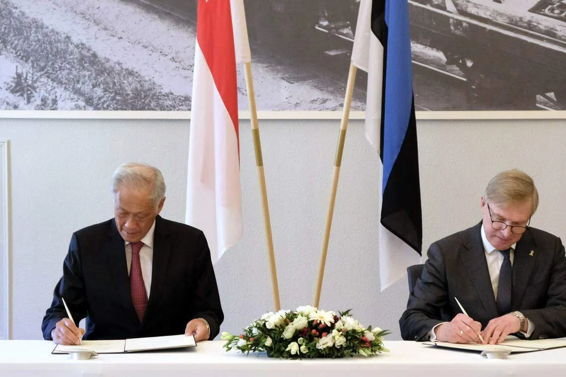 Singapore Minister for Defence Ng Eng Hen and his Estonian counterpart, Kalle Laanet, signing a memorandum on bilateral defence cooperation.