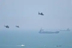 Chinese military helicopters fly past Pingtan island, one of mainland China's closest point from Taiwan, in Fujian province on August 4, 2022, ahead of massive military drills off Taiwan. 