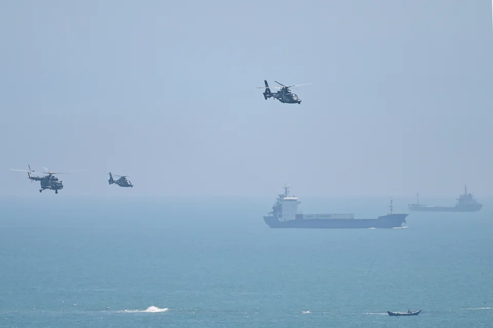 Chinese military helicopters fly past Pingtan island, one of mainland China's closest point from Taiwan, in Fujian province on August 4, 2022, ahead of massive military drills off Taiwan. 
