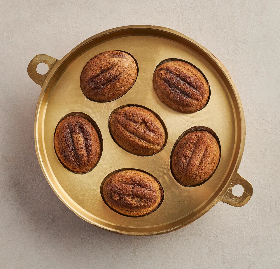 Show-stopping kueh bahulu freshly baked in brass pans.