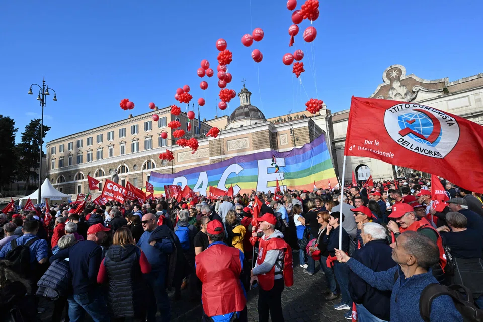 People gather at Piazza del Popolo during a national day of strike on Nov 17, 2023. The walkout was called by two of the country's largest unions, the CGIL and UIL, which say the Italian government's tax-cutting budget woefully underfunds key sectors such as health, education and industry. 