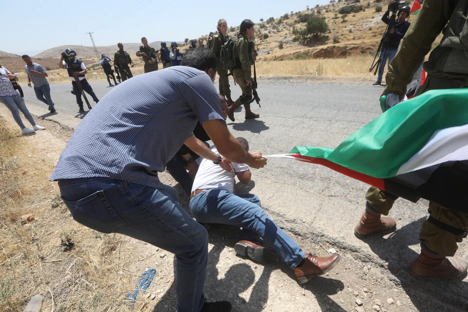 Palestinian protesters clash with Israeli soldiers at Tayaseer checkpoint as they try to cross the checkpoint to reach the Jordan valley, near the West Bank city of Tubas, 06 June 2022. 