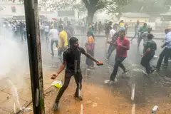 Opposition activists attacking police during a protest to get the government to hold local council elections on March 9. The election commission says it does not have funds to hold the polls.