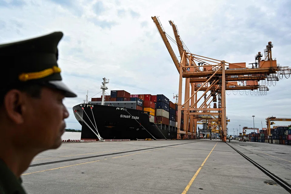 A border guard stands near a cargo ship at Tan Vu port in Hai Phong near Hanoi. Vietnam seeks to be a transshipment hub and a critical node of the supply chain between Asean and China.