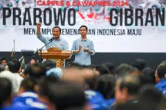 Prabowo Subianto (left) and Gibran Rakabuming Raka (right) were met by thousands of cheering supporters in the capital Jakarta as they handed their credentials and manifesto to election officials.